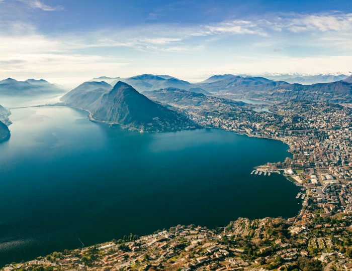 Lugano, Switzerland. Amazing aerial view of the Swiss city, surrounded by lake and mountains.